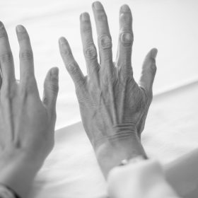 persons left hand on white textile