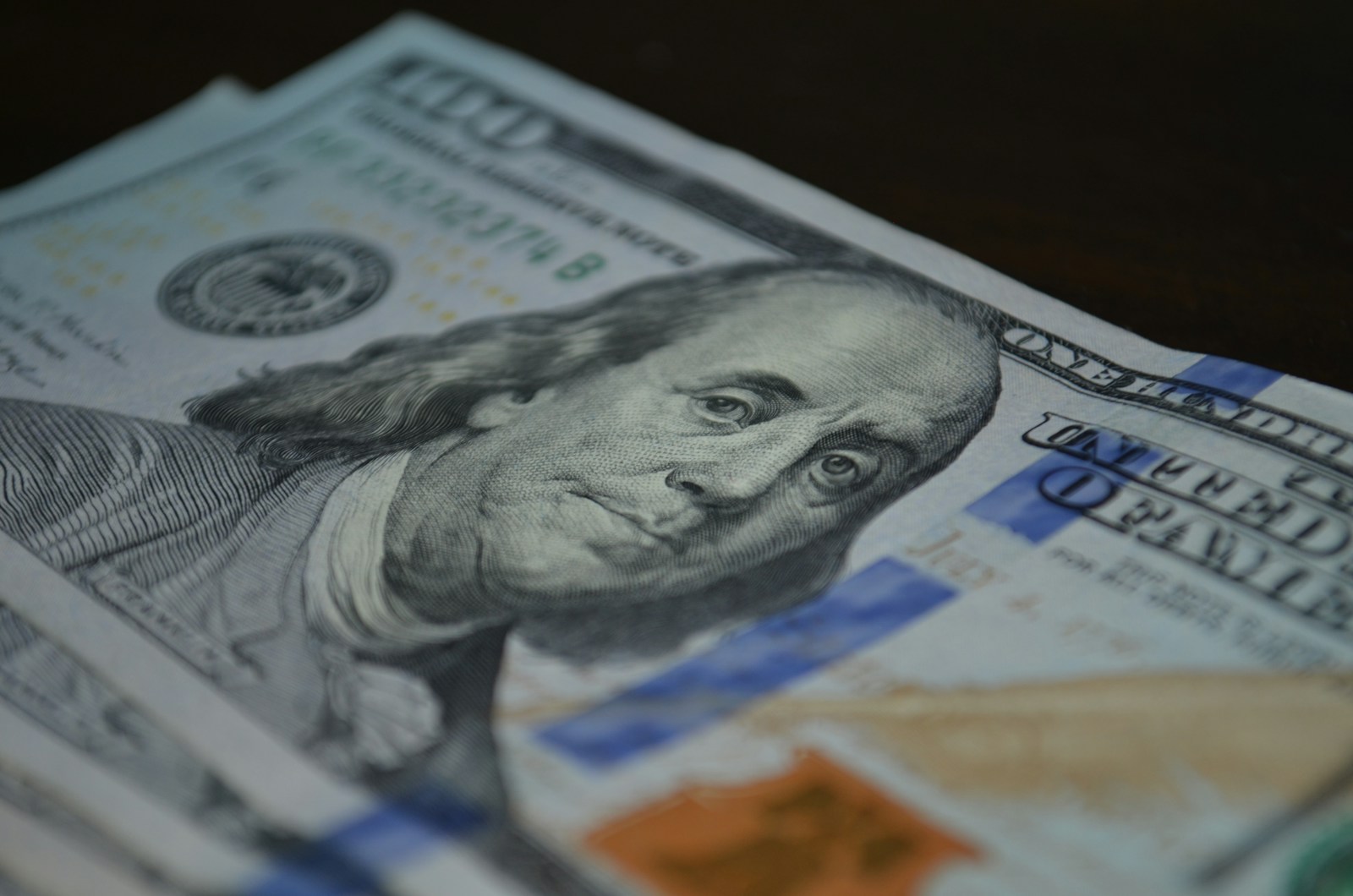 a stack of twenty dollar bills sitting on top of a table